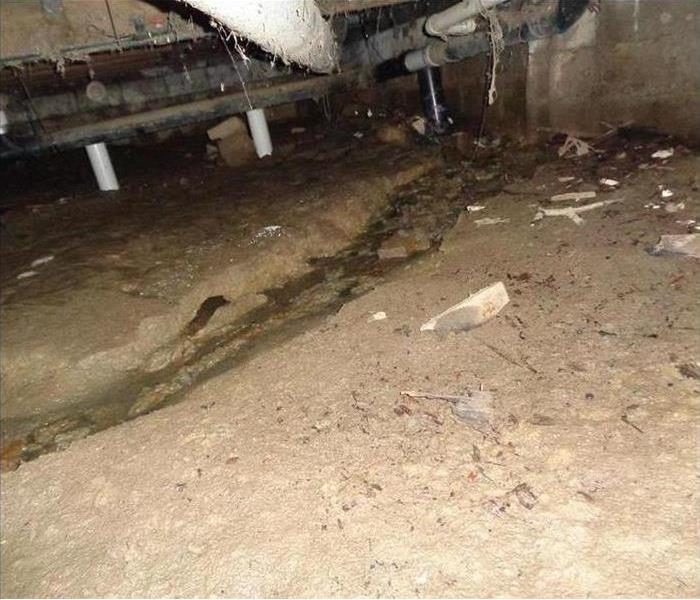 A picture of a crawl space with water damage. 