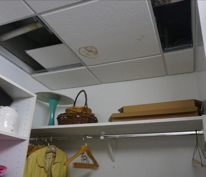 A tile in the closet affected by a water leak above it