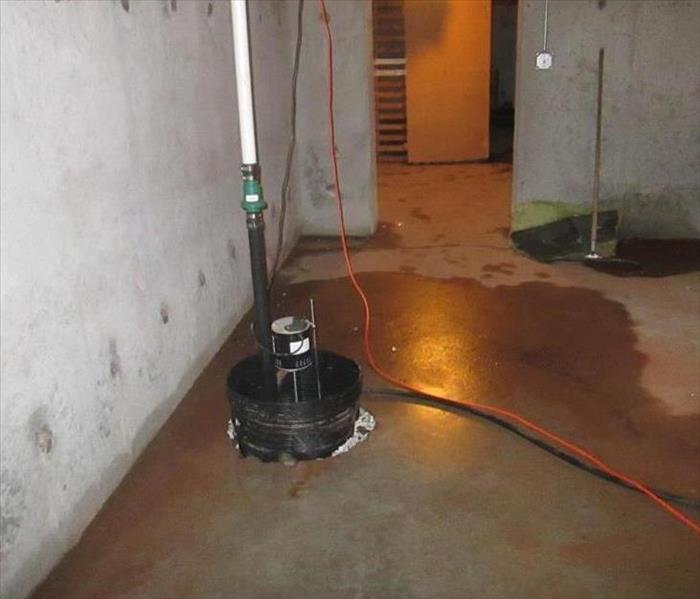 A picture of someone's flooding basement due to a sump pump.